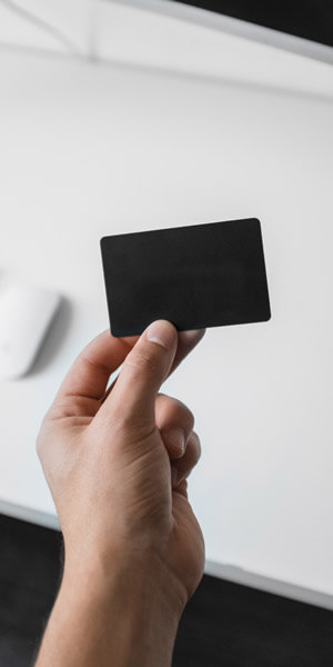 A man holding a black credit card